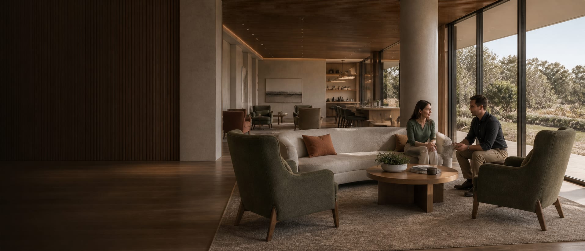 Design-led commercial lounge with supportive seating and two people discussing furniture finishes